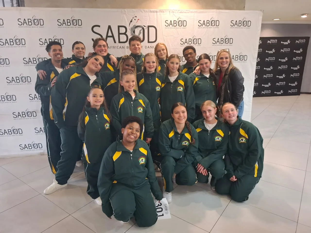JJDC dancers posing with medals in front of a SABOD competition backdrop