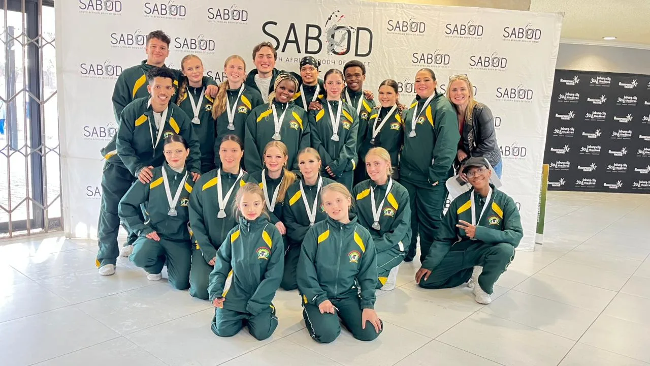 JJDC's national squad in green and gold South African tracksuits posing with medals at a SABOD event