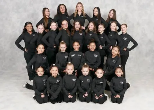 The entire Jo Jackson Dance Company gathered in matching black rehearsal wear for a tiered studio group portrait